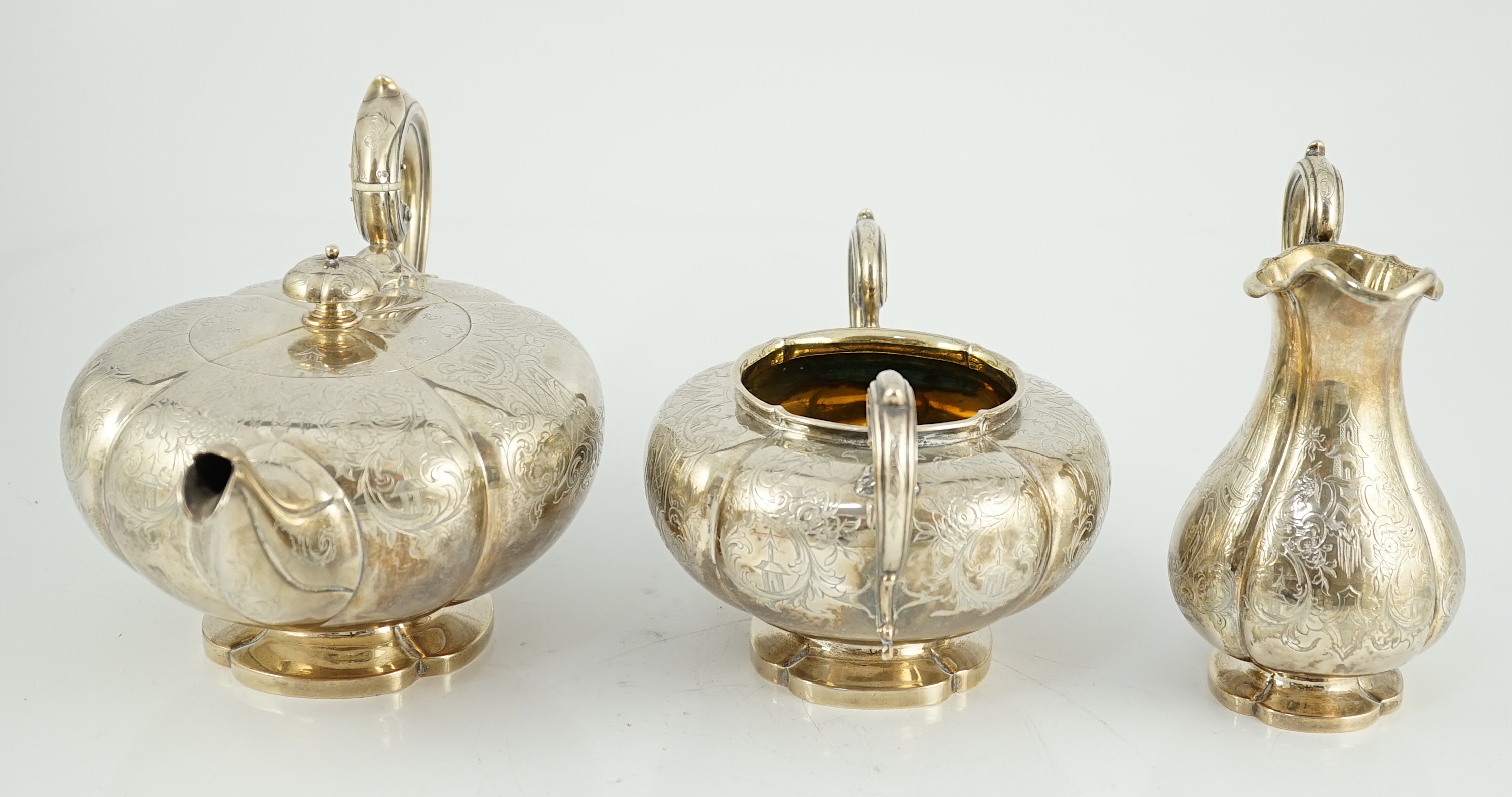 A Victorian silver three piece melon shaped tea set, by Charles Reily & George Storer